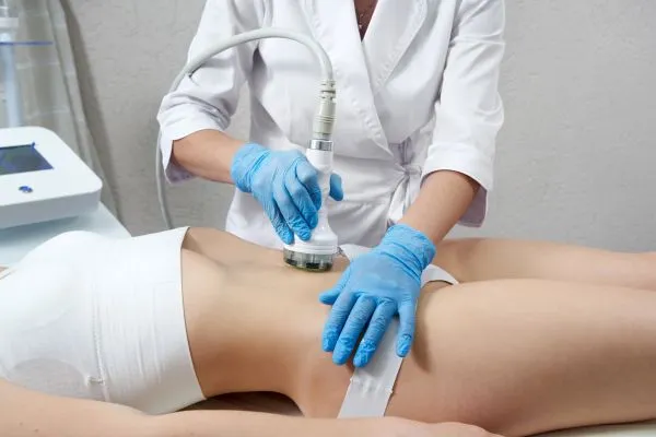 Lost the Weight but Not the Loose Skin? 2 woman having HIFU treatment on her stomach to combat loose skin Ashby-de-la-Zouch following weight loss